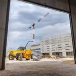 JCB 508-66TC Telehandler carrying pallet of materials.