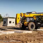 JCB 509-42 Telehandler carrying cement block.
