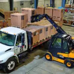 JCB 55-28G Teletruk stacking boxes on truck trailer.