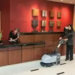 Advance SC351 professional scrubber cleaning hotel lobby.