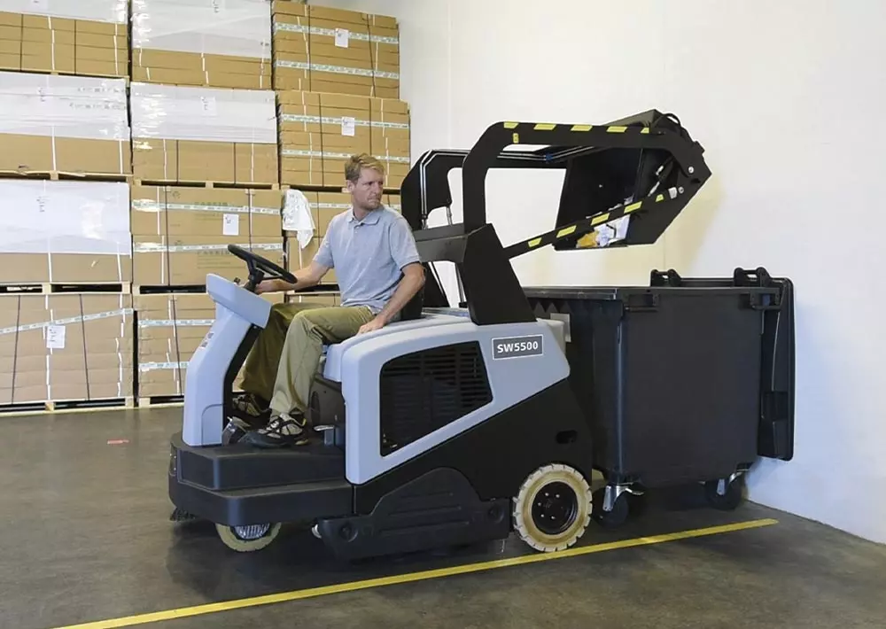 Advance SW5500 rider sweeper dumping debris into garbage.