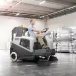 Advance SW5500 rider sweeper cleaning indoor warehouse floors.