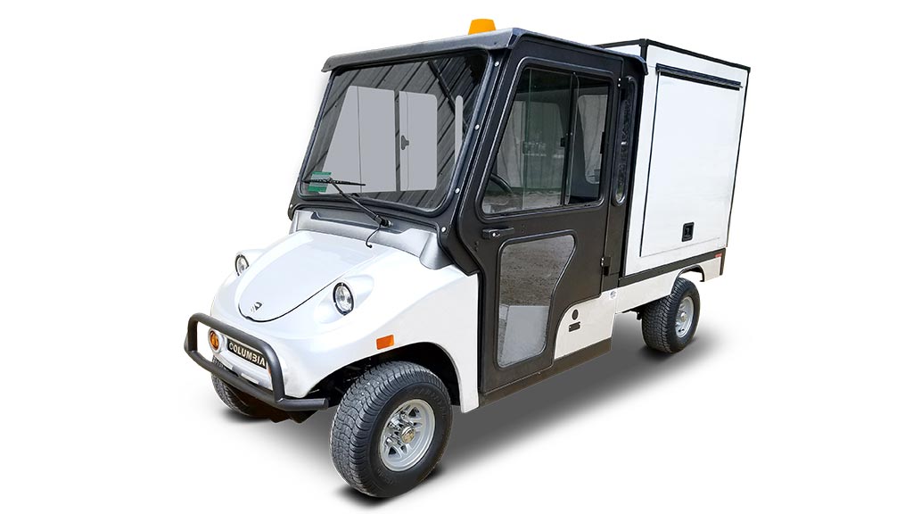 Columbia Utilitruck utility vehicle with cab and custom bed cover.