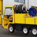 Yellow Columbia Custom Platform utility vehicle with custom bed additions, and cab.