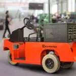 Red Columbia Expediter transportation vehicle in work shop with toolbox on back.