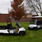 Columbia Journeyman utility vehicles parked on grass.
