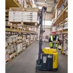 Combilift Combi-CS 4400 Pedestrian Stacker lifting pallet in warehouse.