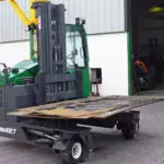 Combilift C10,000XL Forklift carrying material outdoors.