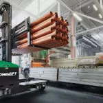 Combilift C Series C6000E electric forklift carrying materials in warehouse.