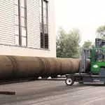 Combilift C-Series forklift truck moving a long steel pipe.
