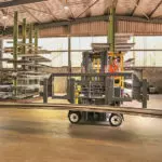 Combilift COMBI-CB Forklift transporting long steel slabs in specialty metals and steel industry.