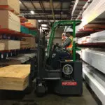 Combilift COMBI-CB Forklift carrying wood in lumber warehouse.