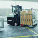 Combilift COMBI-CB8E Electric Forklift carrying vinyl, siding and roofing supplies outdoors.