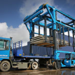 Combilift SC3 Telescopic Toplift straddle carrier handling concrete slabs.