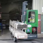 Combilift SL12000 Multi Directional Side Loader Forklift Truck carrying materials outdoors.