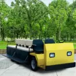 Yellow Columbia Custom Platform utv outdoors, with bench feature added on back.