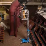 repairman raised in Genie AWP-25S Aerial Work Platform.