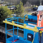 Genie fall arrest bar installed on a boom lift.