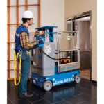 Genie GR-15 vertical mast lift being pushed into an elevator.