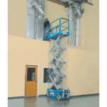 Duct repairman in bucket of Genie GS-1930 slab scissor lift.