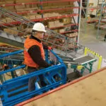 worker in Genie GS-4046 scissor lift bucket.