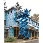 Construction workers in bucket of Genie GS-4069 DC scissor lift working on a house.