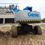 back of Genie S-40 HF and S-45 HF Telescopic Boom Lift in dirt on construction site.