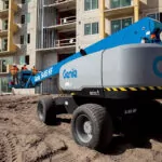 Genie S-85 HF telescopic boom lift on rough terrain.