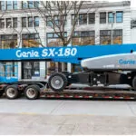 Genie SX-180 aerial boom lift on a trailer.