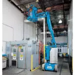 Genie Z-30/20 N articulating boom lifting operator to the ceiling.