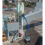 Genie Z-45 XC lifted along tall building.