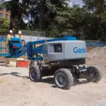Genie Z-45 XC articulating boom lift: lift down, driving outdoors.