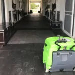 IPC Eagle 512 walk-behind sweeper parked outside horse stable.