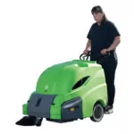 Woman behind IPC Eagle 512 walk-behind sweeper.