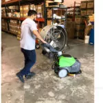 IPC Eagle CT15 walk-behind scrubber cleaning warehouse floors.