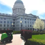 IPC Eagle CT160 rider scrubber parked outside of a large, official building.