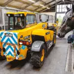 JCB 505-20E Telescopic Handler transporting hay in horse stables.