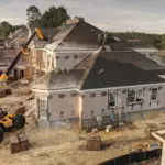 JCB 509-42 Telescopic Handler lifting materials to roof workers.