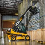 JCB 55-28G Teletruk stacking pallet of materials.