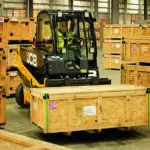 JCB 66-44G Teletruk transporting wooden pallet.