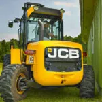 JCB 940 rough terrain forklift in a freshly mowed field.