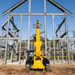 JCB 510-56 Telehandler lifting materials on building work site.