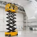 JCB S4046 Electric Scissor Lift extended with two technicians inspecting airplane wing.