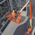 Workers being raised in JLG 1500SJ telescopic boom lift.