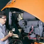 Mechanic working on JLG 400S boom lift.