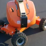 Top view of JLG 600AJ articulating boom lift wheel area.