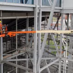 JLG 1500SJ telescopic boom lift at outdoor facility.