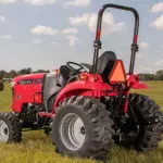 Mahindra 1635 Compact Utility Tractor: back angled view, parked in grass field.