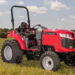 Mahindra 1635 Compact Utility Tractor parked in open grass field.
