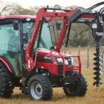 Mahindra 2638 cab compact utility tractor with auger attachment.